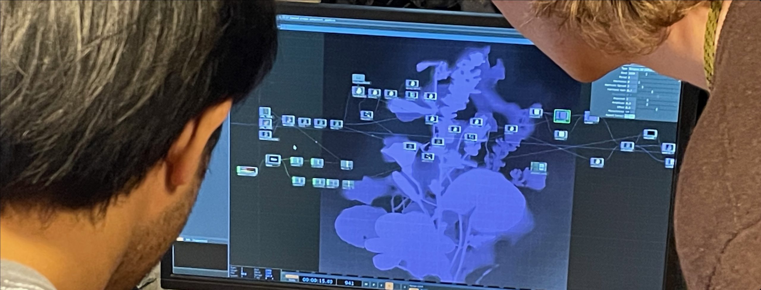 Students looking at visual programming layout on computer screen